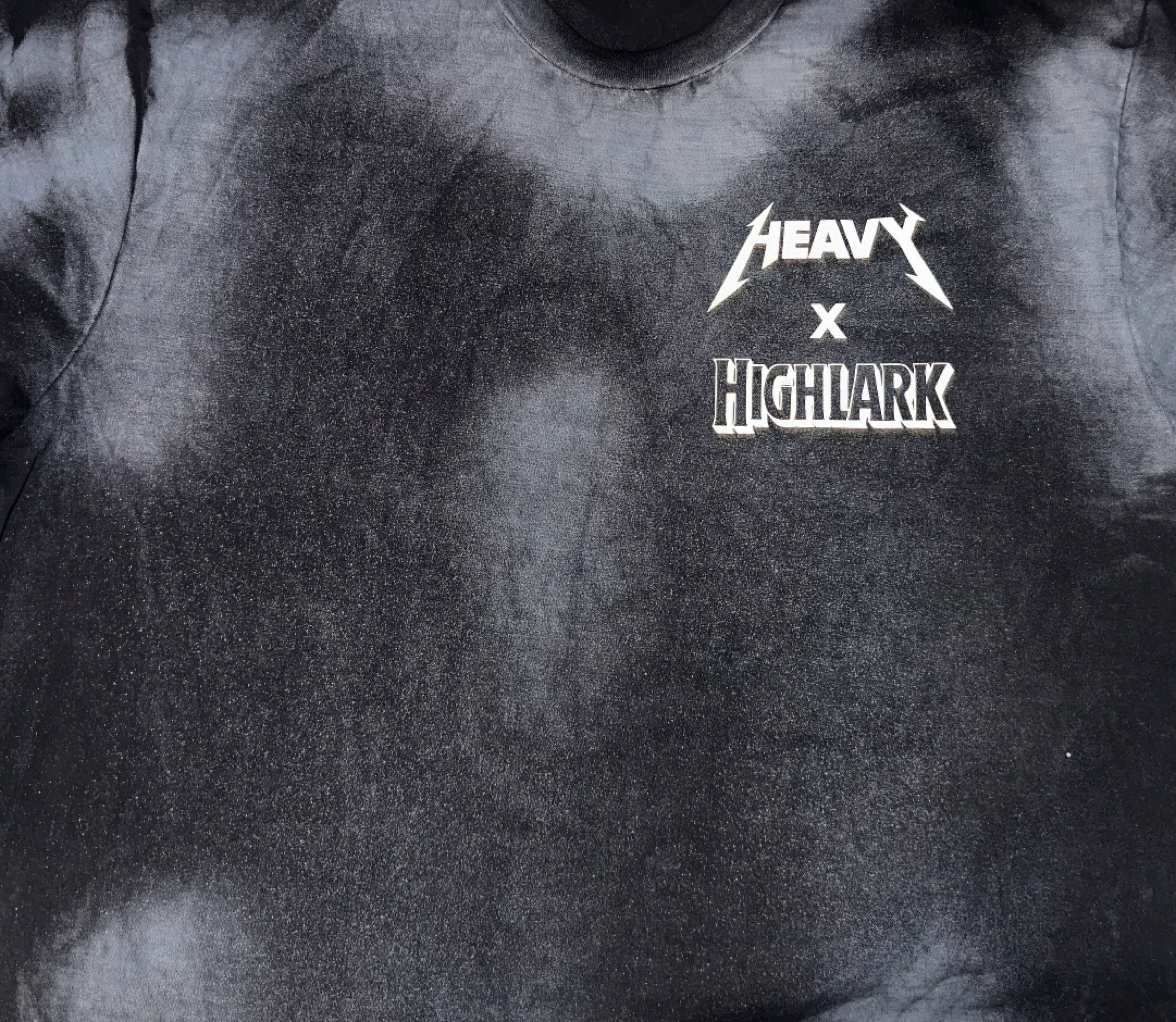 HEAVY x Highlark left-chest collaborative logo lockup printed off-white on vintage washed black heavyweight cotton tee.