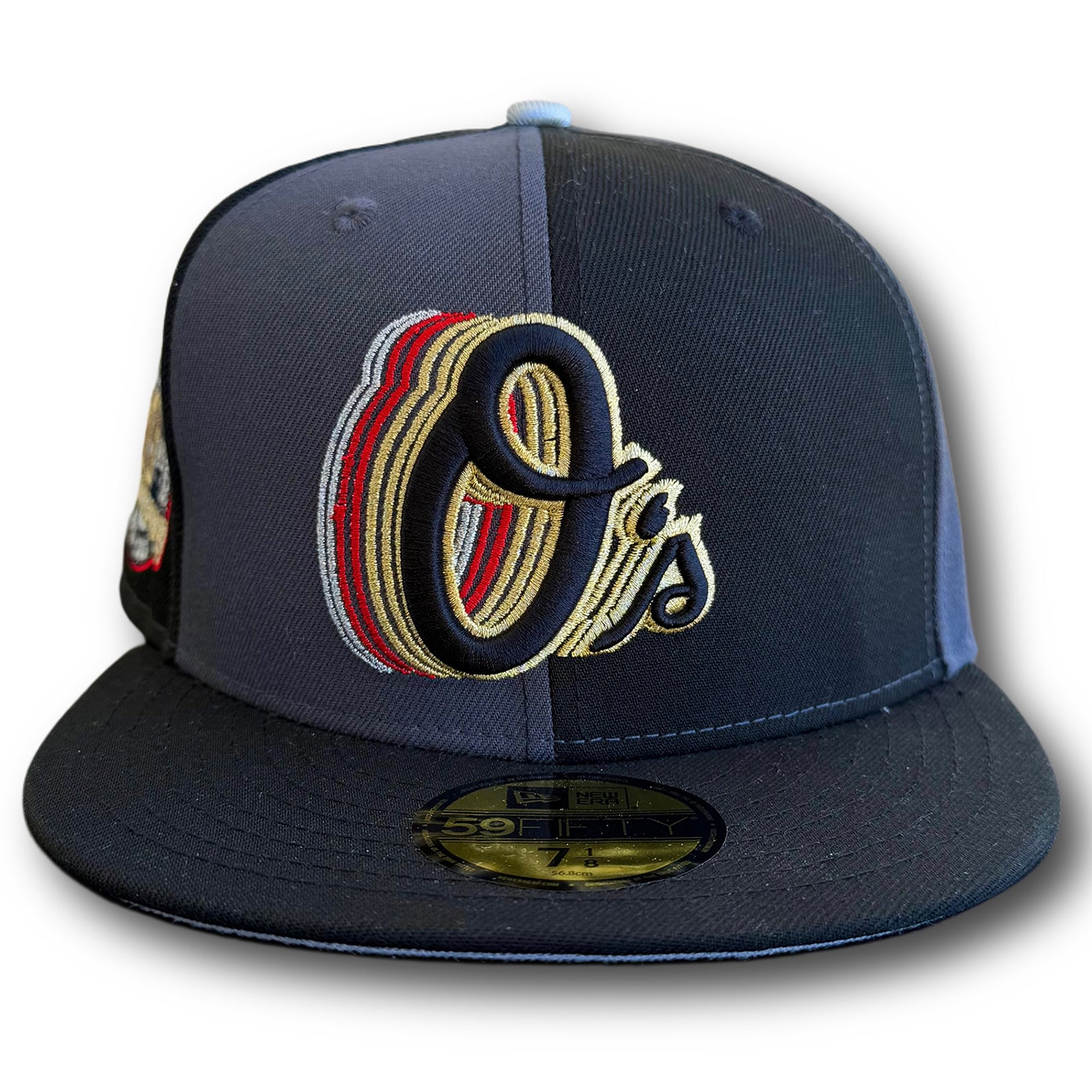 Front view of Highlark Orioles 007 James Bond fitted hat showing layered Cascading O's logo in black, red, gold, and silver