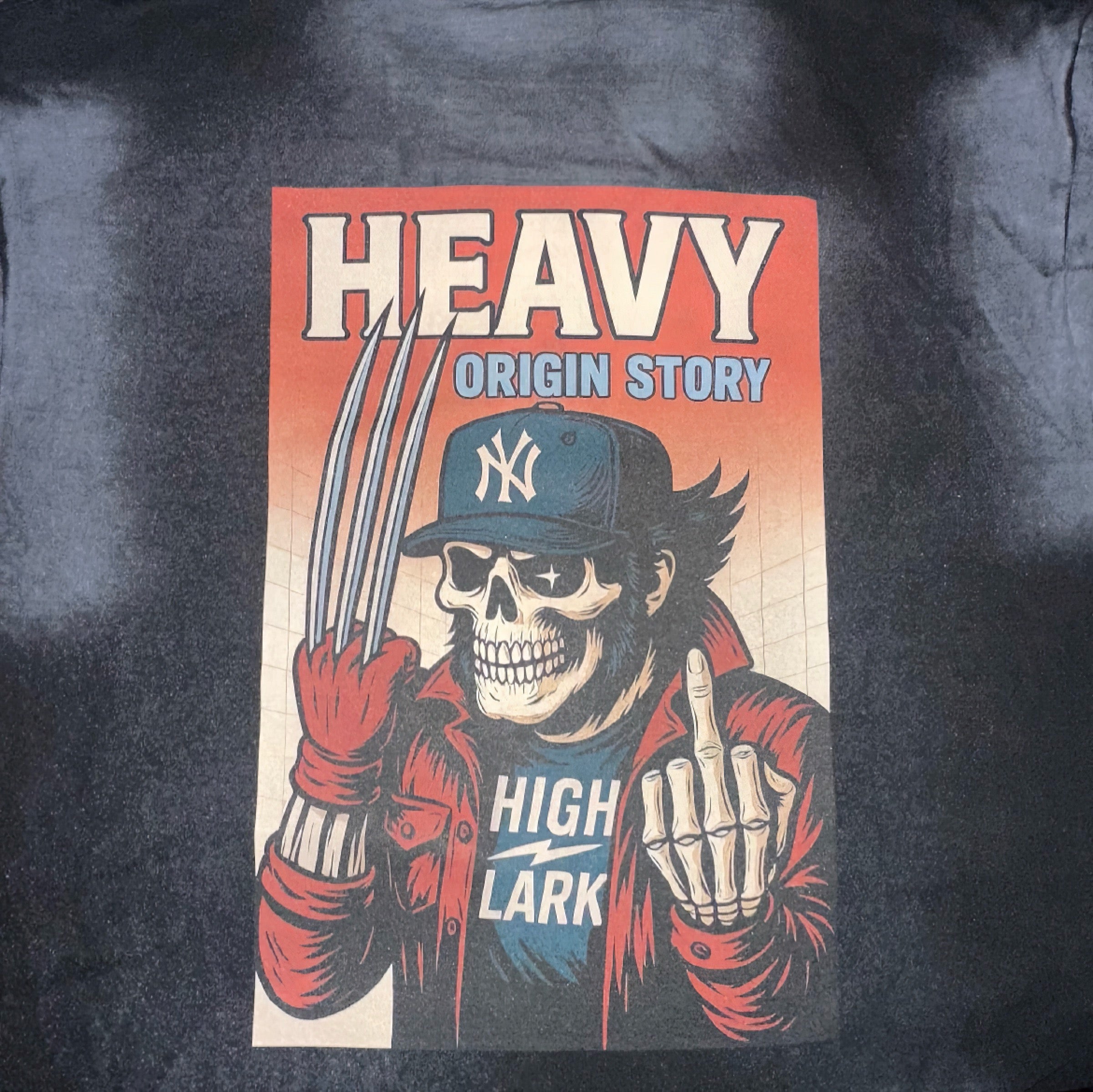 HEAVY x Highlark Wolverine Origin Story tee back graphic detail. Skeletal Wolverine figure with Yankees fitted, red flannel, claws extended, ORIGIN STORY framing.
