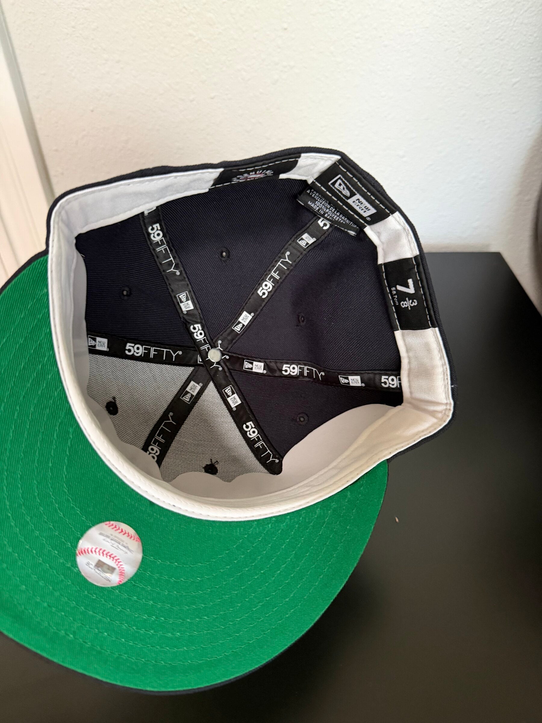 Interior with white sweatband and green undervisor, size 7 3/8