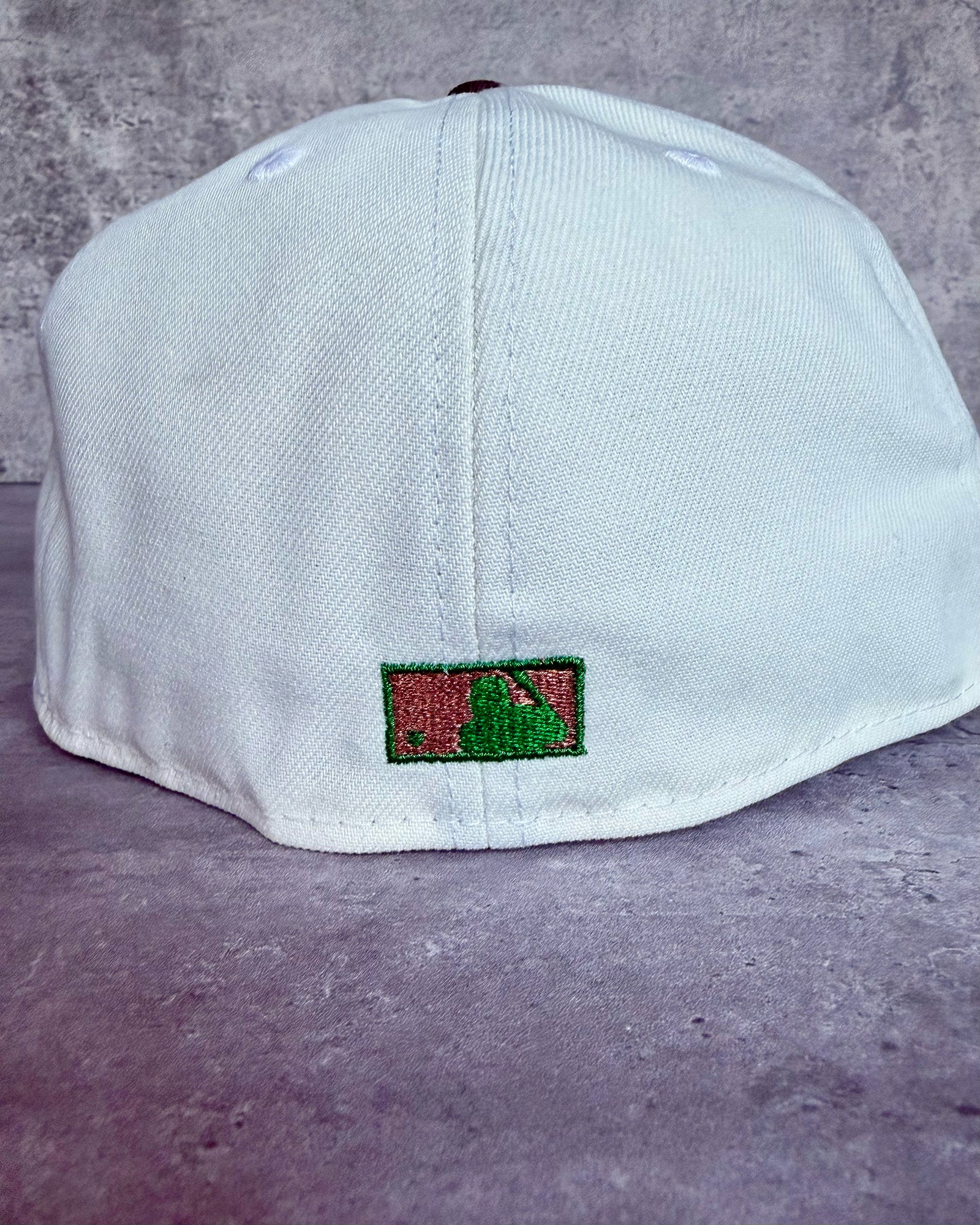 Back view of Highlark Orioles 1.0 fitted hat showing metallic copper and green MLB batterman embroidery