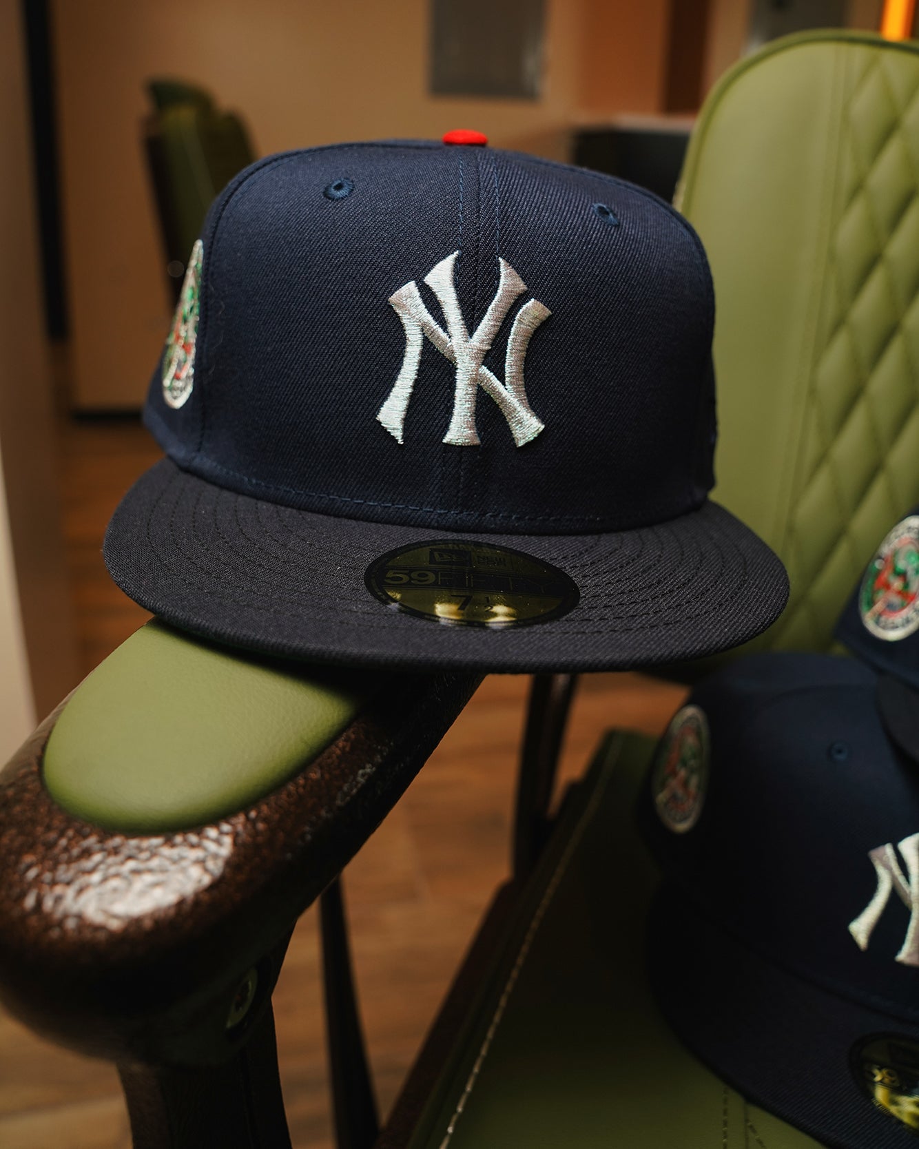 Highlark Timeless Yankees fitted hat with 1949 World Series patch, navy crown, displayed on vintage green leather chair