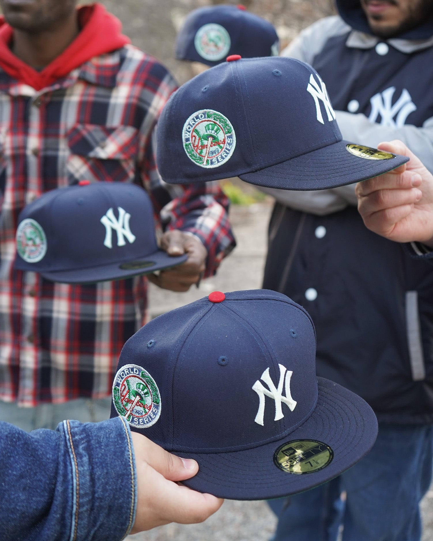 Highlark Timeless Yankees fitted hat held in hands showing navy crown, red button, and 1949 World Series patch